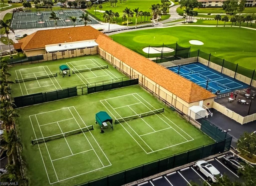 103 Teryl Road, Unit A4 Naples, FL 34112 - Photo 3 of 10 a view of a tennis ground with a swimming pool