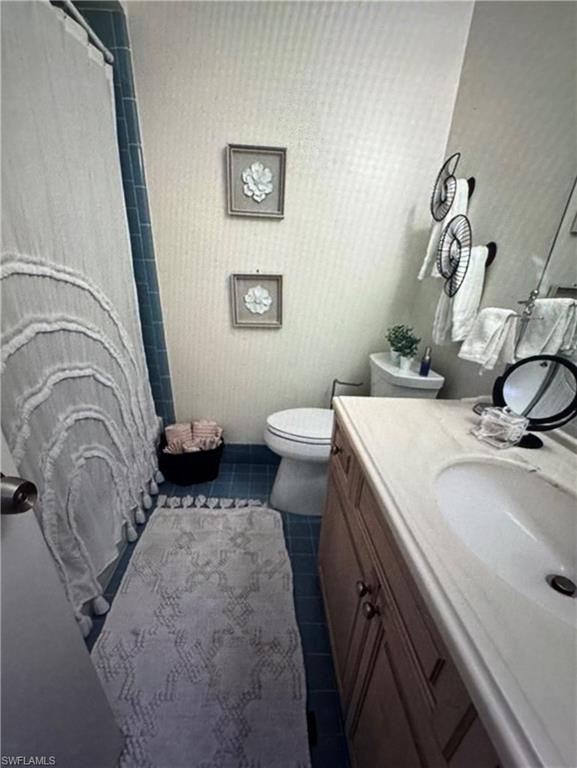 103 Teryl Road, Unit A4 Naples, FL 34112 - Photo 10 of 10 a bathroom with a sink a toilet and a mirror