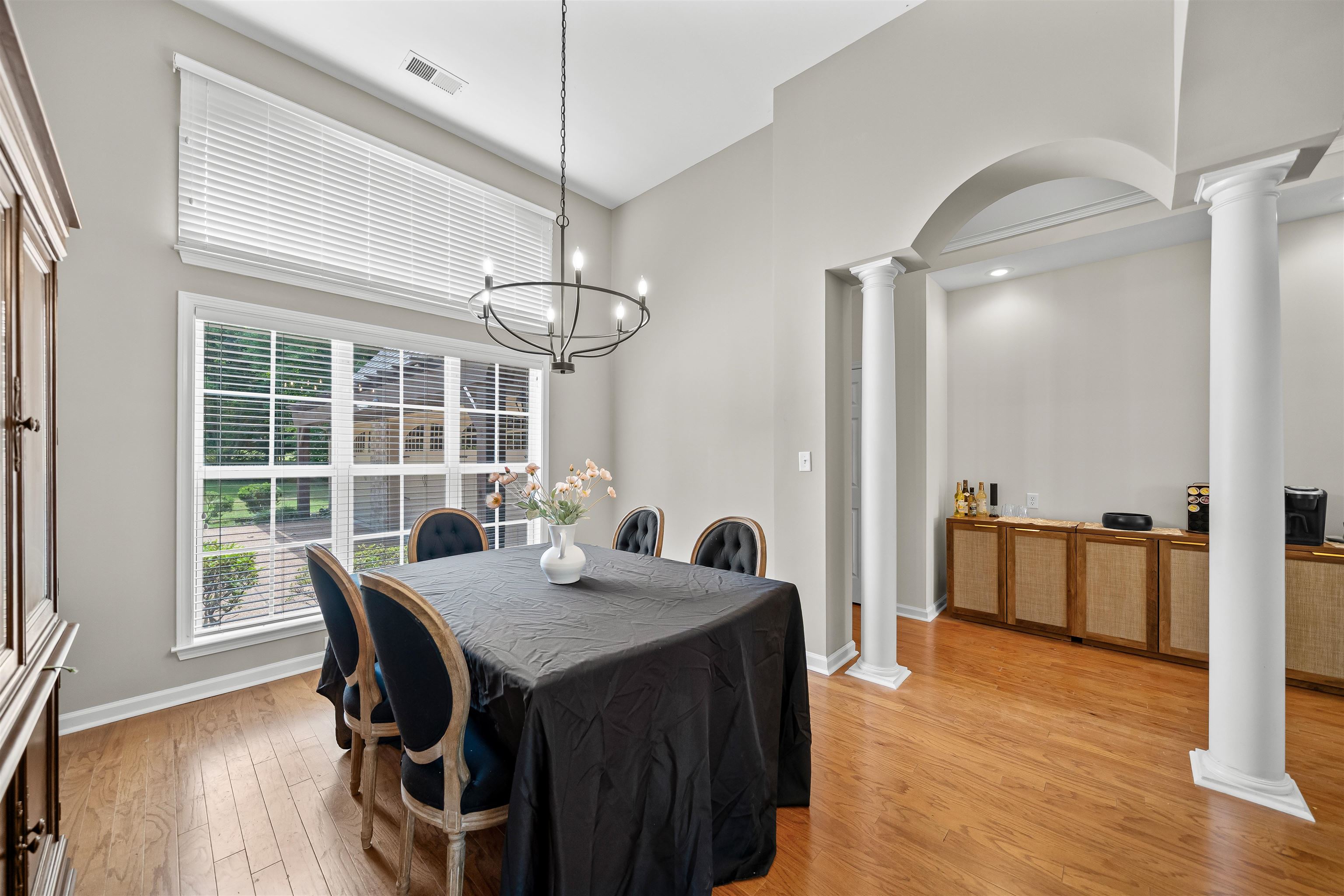 5035 Brian Ridge Road Arlington, TN 38002 - Photo 14 of 40 Hardwood flooring throughout featuring a large window with transom, a high ceiling, and an arched entry with columns