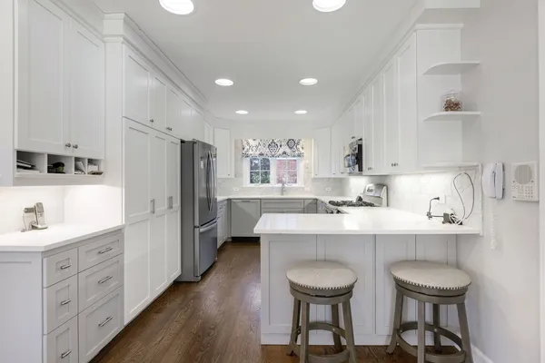 a kitchen with refrigerator a sink and cabinets