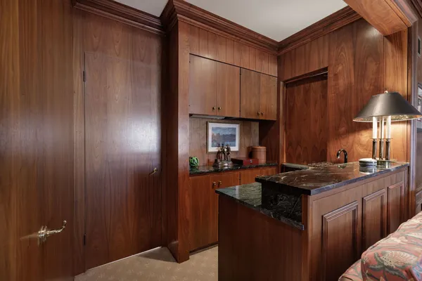 a kitchen with granite countertop a sink stove and cabinets