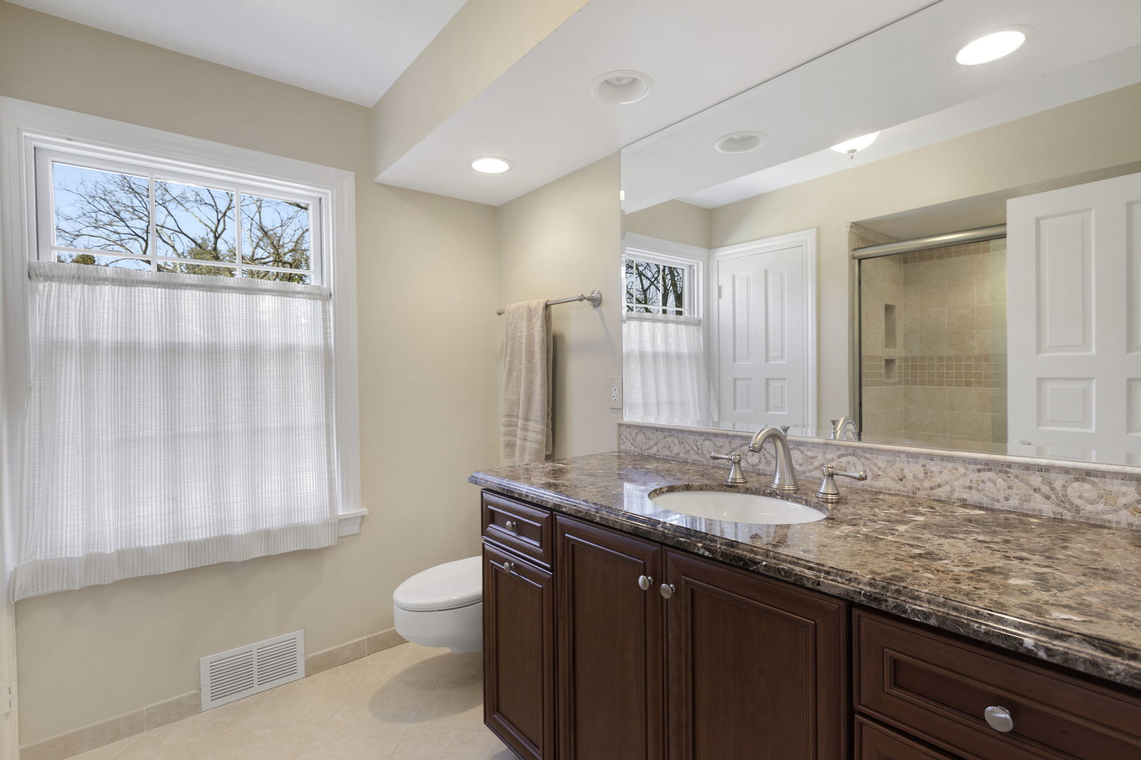 1115 Golfview Lane Glenview, IL 60025 - Photo 31 of 46 a bathroom with a granite countertop sink a toilet and a mirror