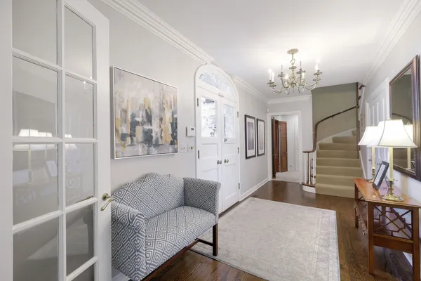a living room with furniture a chandelier and a chandelier