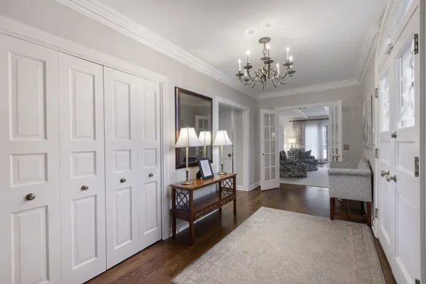 a living room with furniture and a chandelier