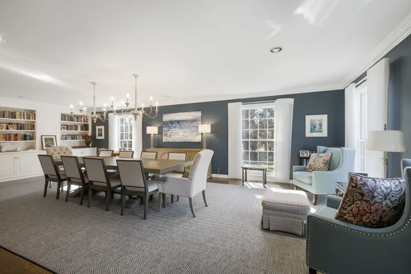 a dining room with furniture and wooden floor