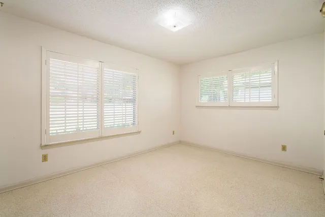 a view of a chair and tables in the garden