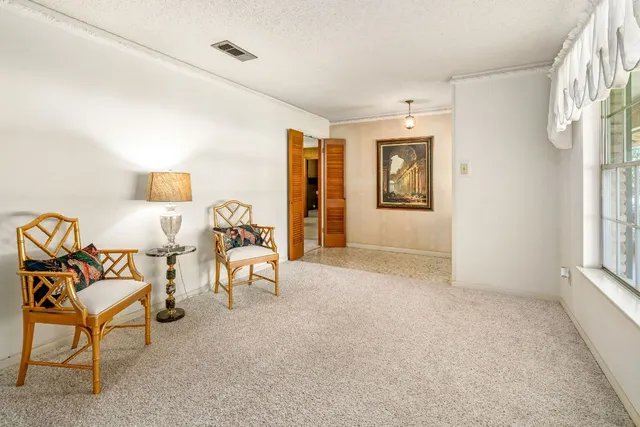 a view of a livingroom with furniture and a window