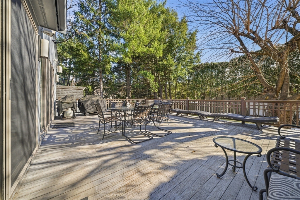 54 Oakvale Road Newton, MA 02468 - Photo 16 of 42 a view of a patio with table and chairs and wooden floor