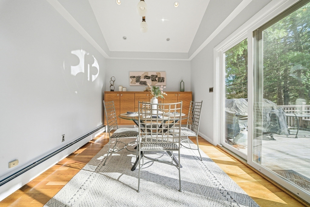 54 Oakvale Road Newton, MA 02468 - Photo 9 of 42 a view of a dining room with furniture wooden floor and a floor to ceiling window
