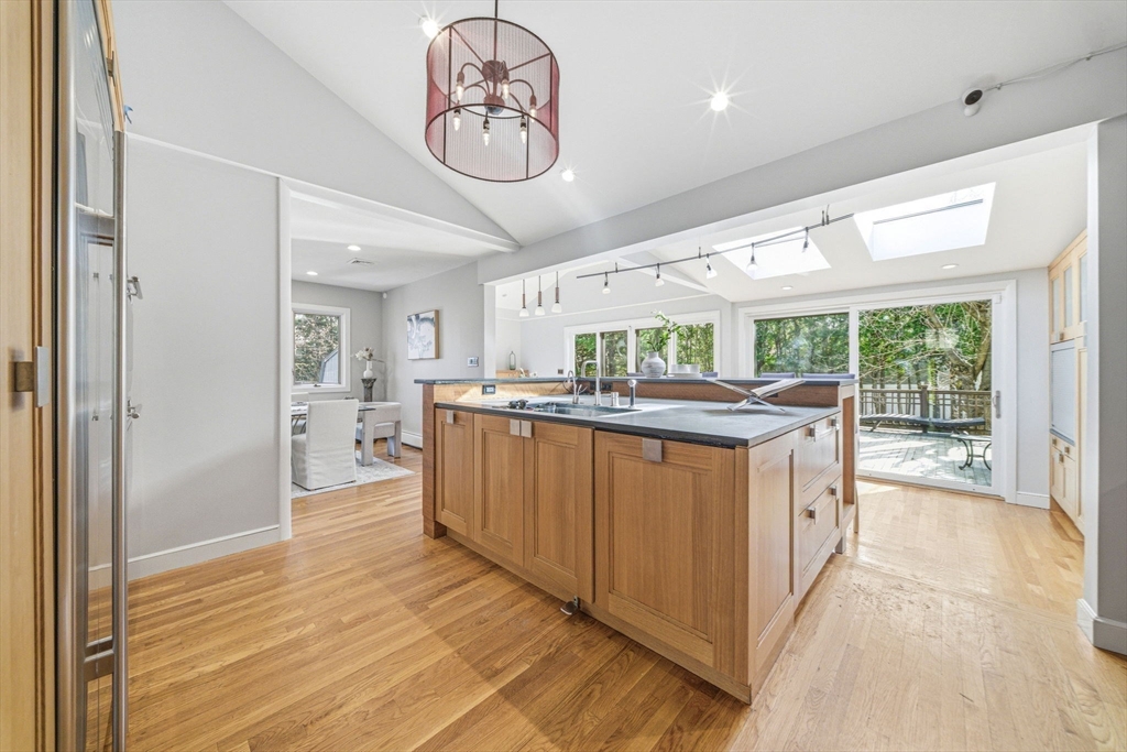 54 Oakvale Road Newton, MA 02468 - Photo 10 of 42 a kitchen with stainless steel appliances granite countertop a large stove a refrigerator a oven with white cabinets and wooden floor