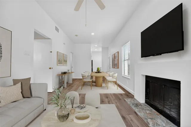 a living room with furniture a fireplace and a flat screen tv