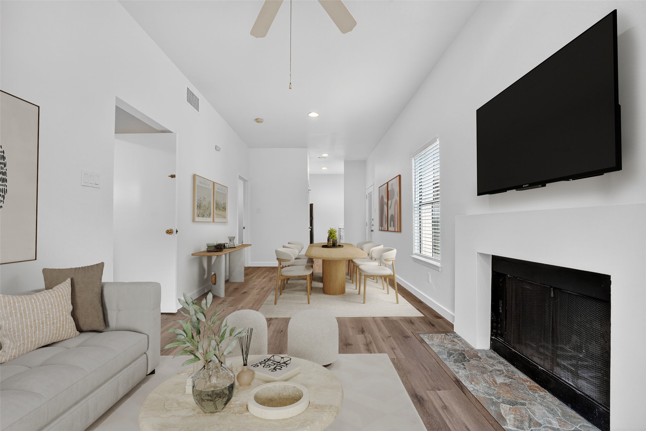 a living room with furniture a fireplace and a flat screen tv