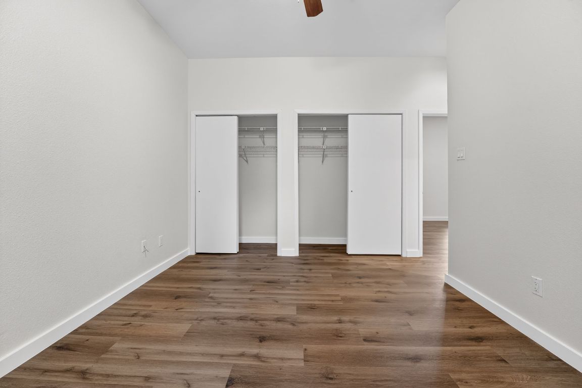 712 Graham Place, Unit 201 Austin, TX 78705 - Photo 22 of 36 a view of an empty room with wooden floor