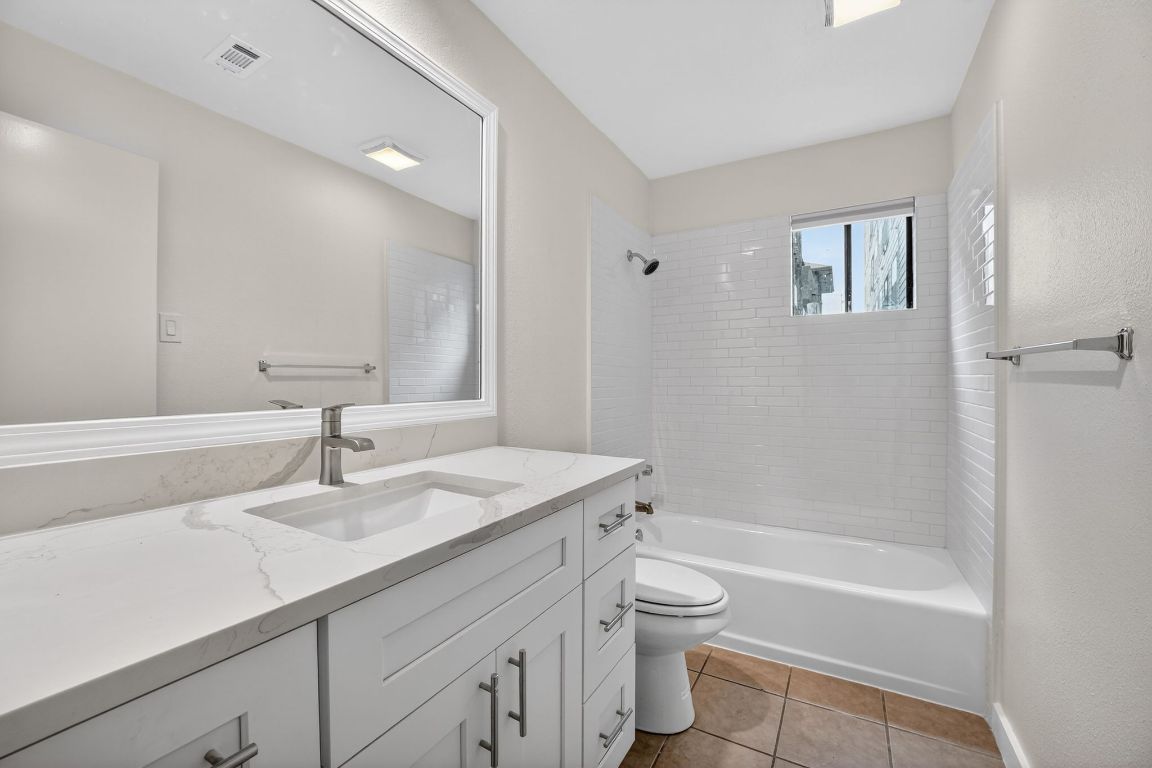 712 Graham Place, Unit 201 Austin, TX 78705 - Photo 23 of 36 a bathroom with a sink a toilet and shower