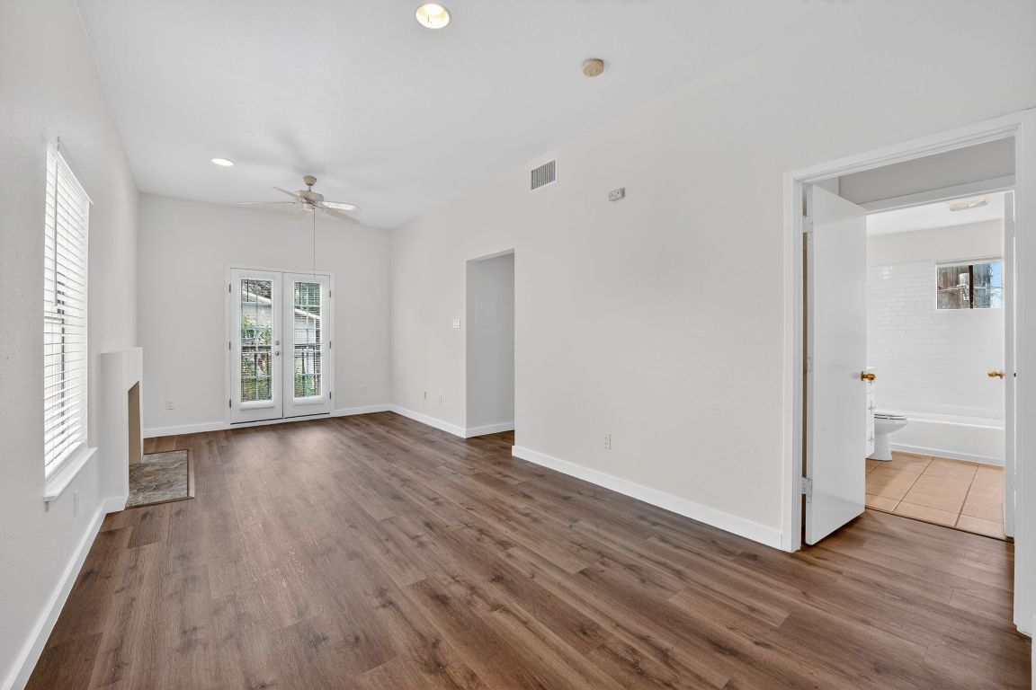 712 Graham Place, Unit 201 Austin, TX 78705 - Photo 24 of 36 wooden floor in an empty room with a window
