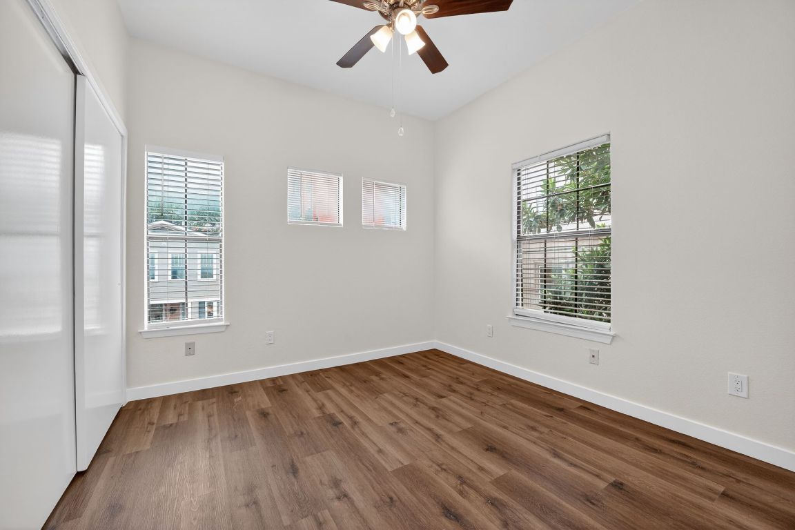 712 Graham Place, Unit 201 Austin, TX 78705 - Photo 25 of 36 a view of an empty room with wooden floor and a window
