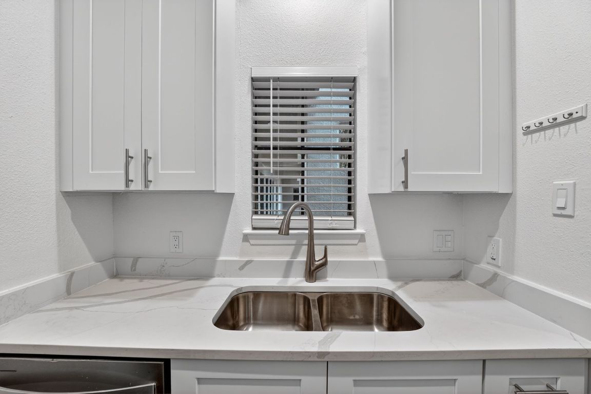 712 Graham Place, Unit 201 Austin, TX 78705 - Photo 9 of 36 a kitchen with a sink and cabinets