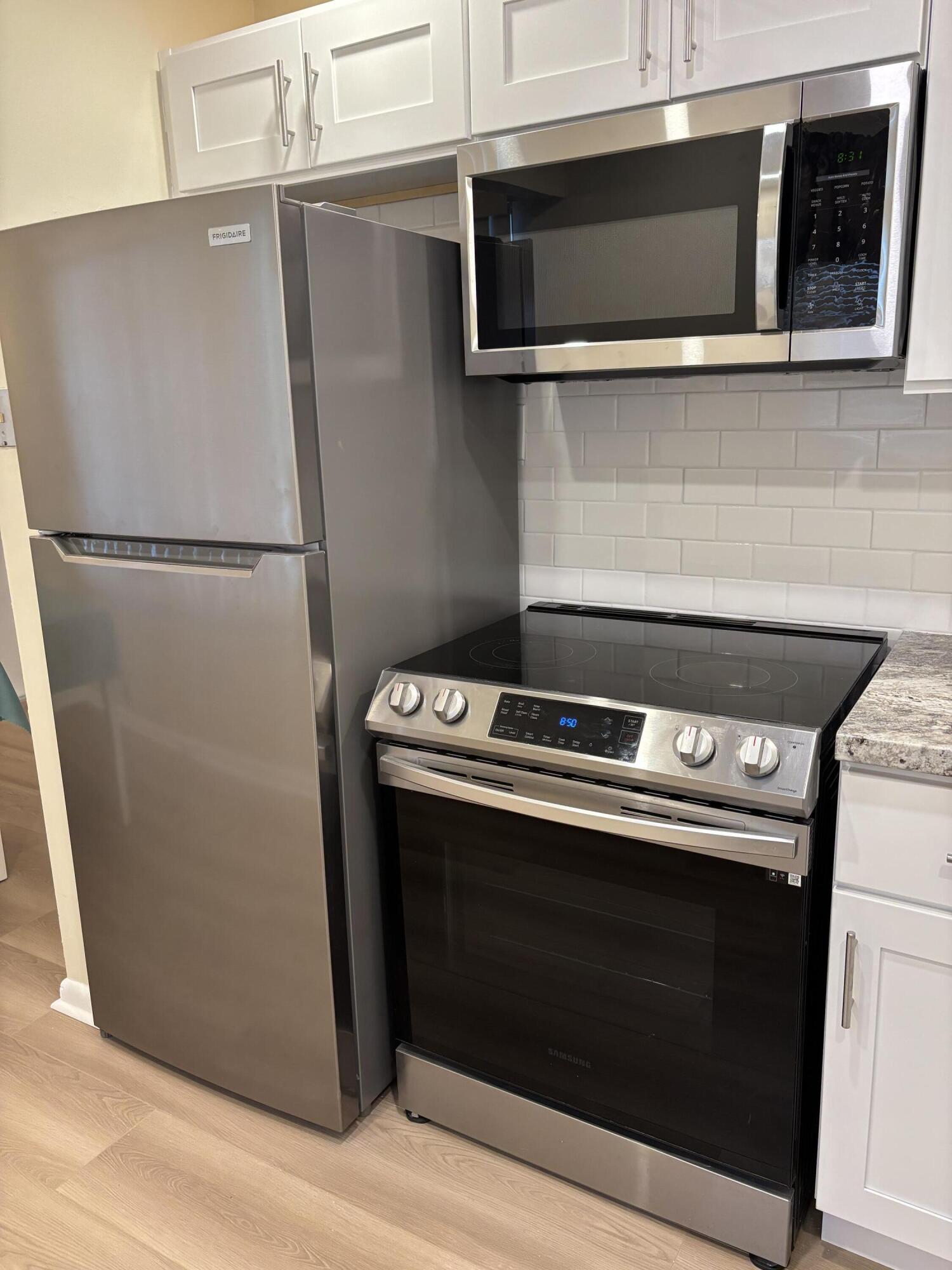 228 Brighton F Boca Raton, FL 33434 - Photo 3 of 24 a stove top oven sitting inside of a kitchen