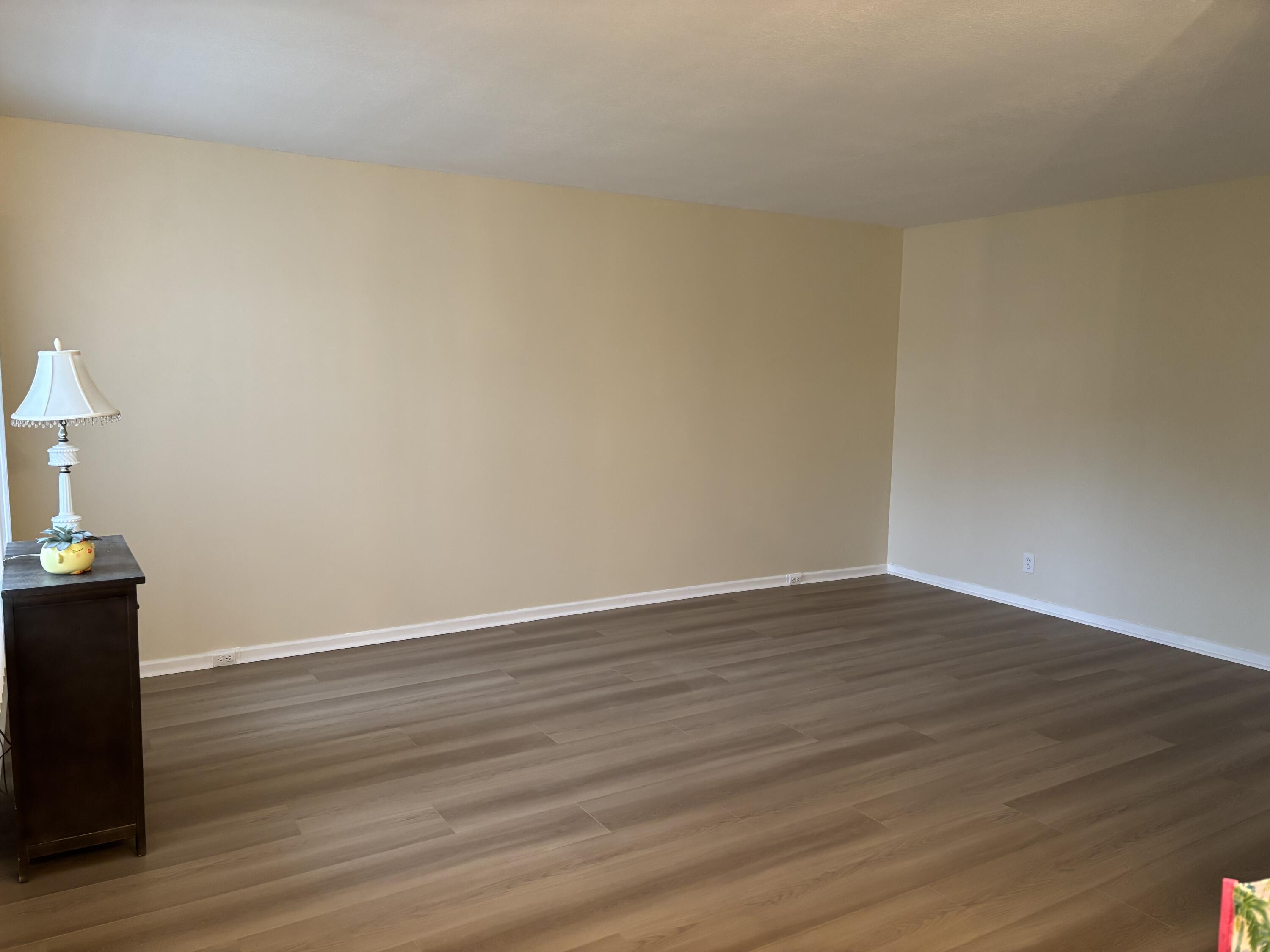 228 Brighton F Boca Raton, FL 33434 - Photo 4 of 24 a view of an empty room and wooden floor
