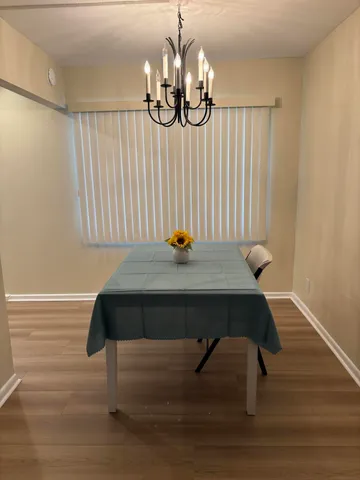 a view of a room with a table and wooden floor