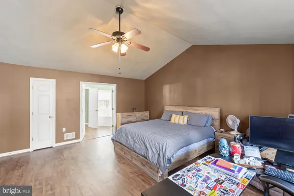 a bedroom with a bed gym equipment and a large window