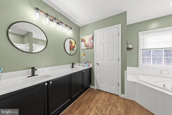 a bathroom with a bathtub and a shower