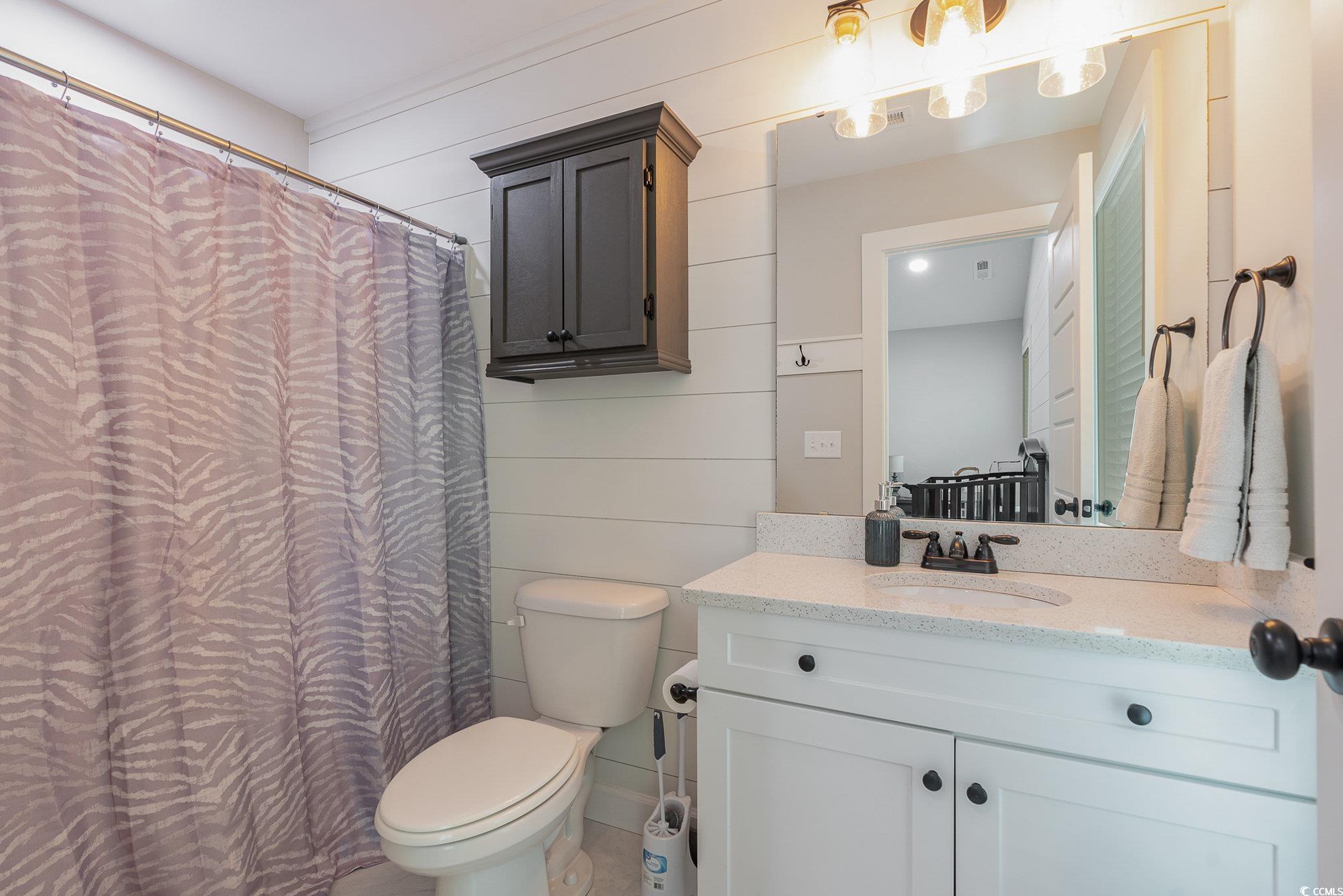 208 Kings Crossing Loop Murrells Inlet, SC 29576 - Photo 15 of 28 Bathroom with curtained shower, vanity, and toilet