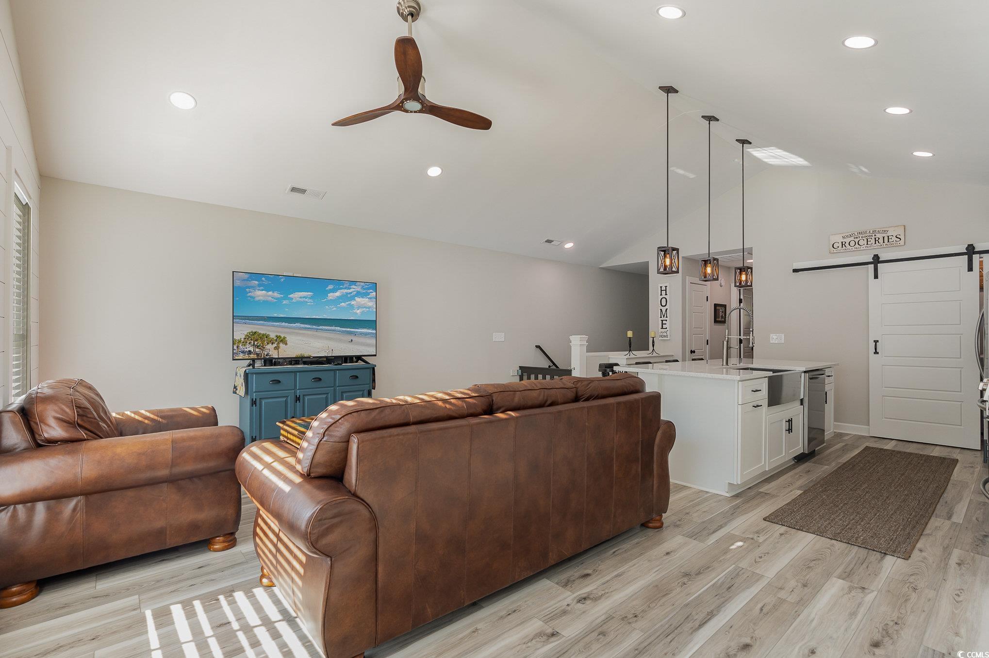 208 Kings Crossing Loop Murrells Inlet, SC 29576 - Photo 7 of 28 Living room with vaulted ceiling, sink, light wood