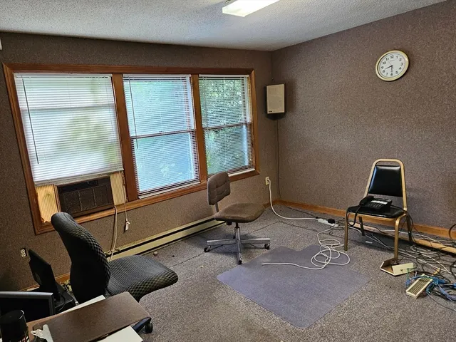 a view of a workspace with furniture and a window