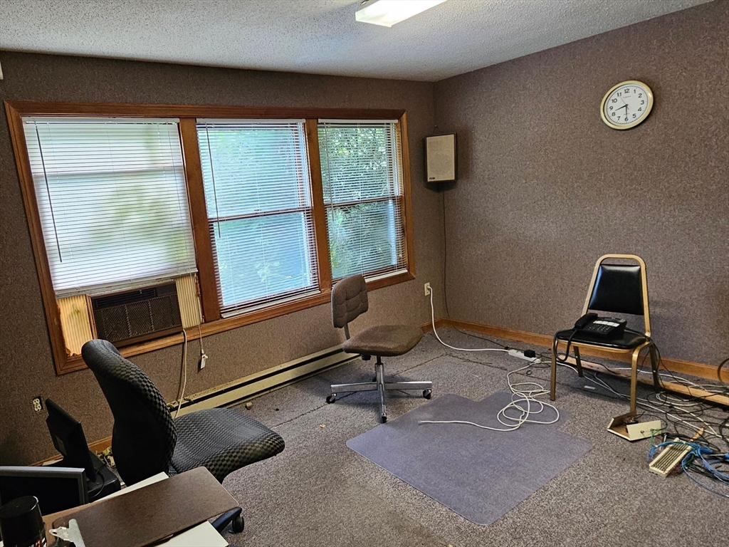 27 Douglas Road Webster, MA 01570 - Photo 14 of 19 a view of a workspace with furniture and a window