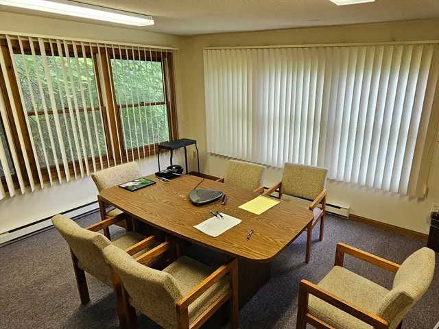a view of a workspace with furniture and window