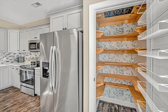 a bathroom with a sink vanity mirror and toilet