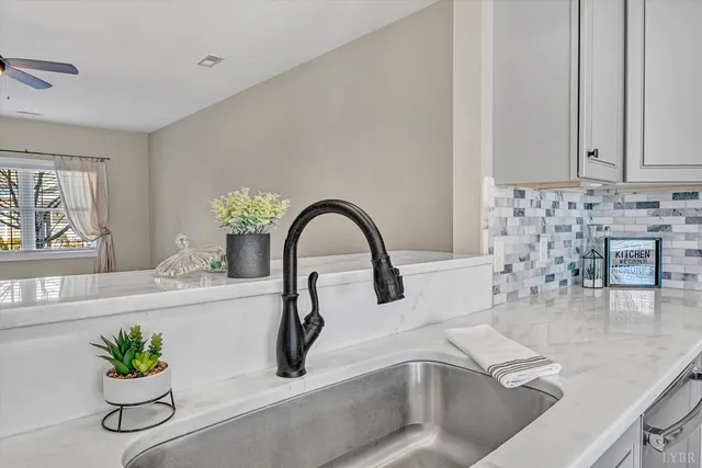 a view of a hallway to a livingroom with wooden floor and staircase