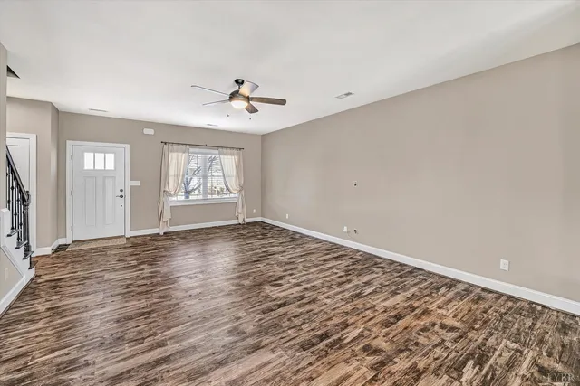 wooden floor in an empty room with a window