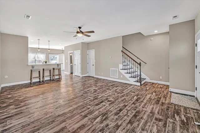 a kitchen with stainless steel appliances granite countertop a refrigerator and a stove