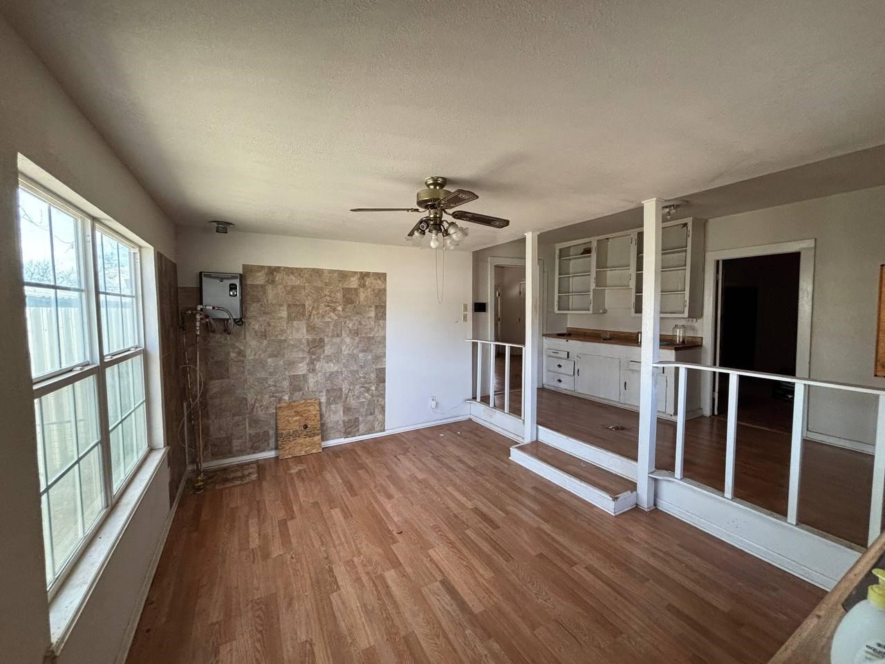308 Martin Street Bangs, TX 76823 - Photo 7 of 14 wooden floor in an empty room with a window