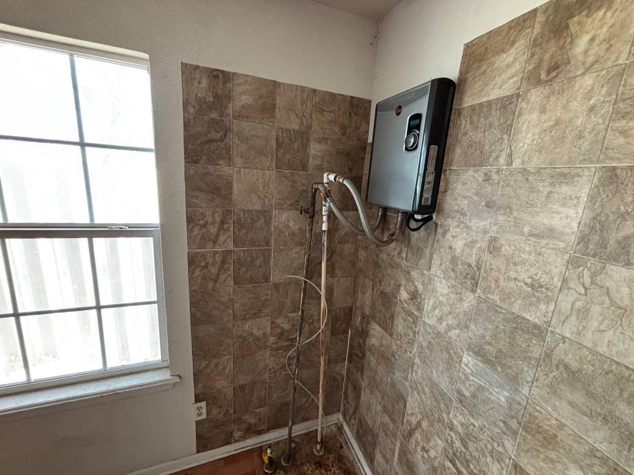 308 Martin Street Bangs, TX 76823 - Photo 8 of 14 a bathroom with a window and a shower