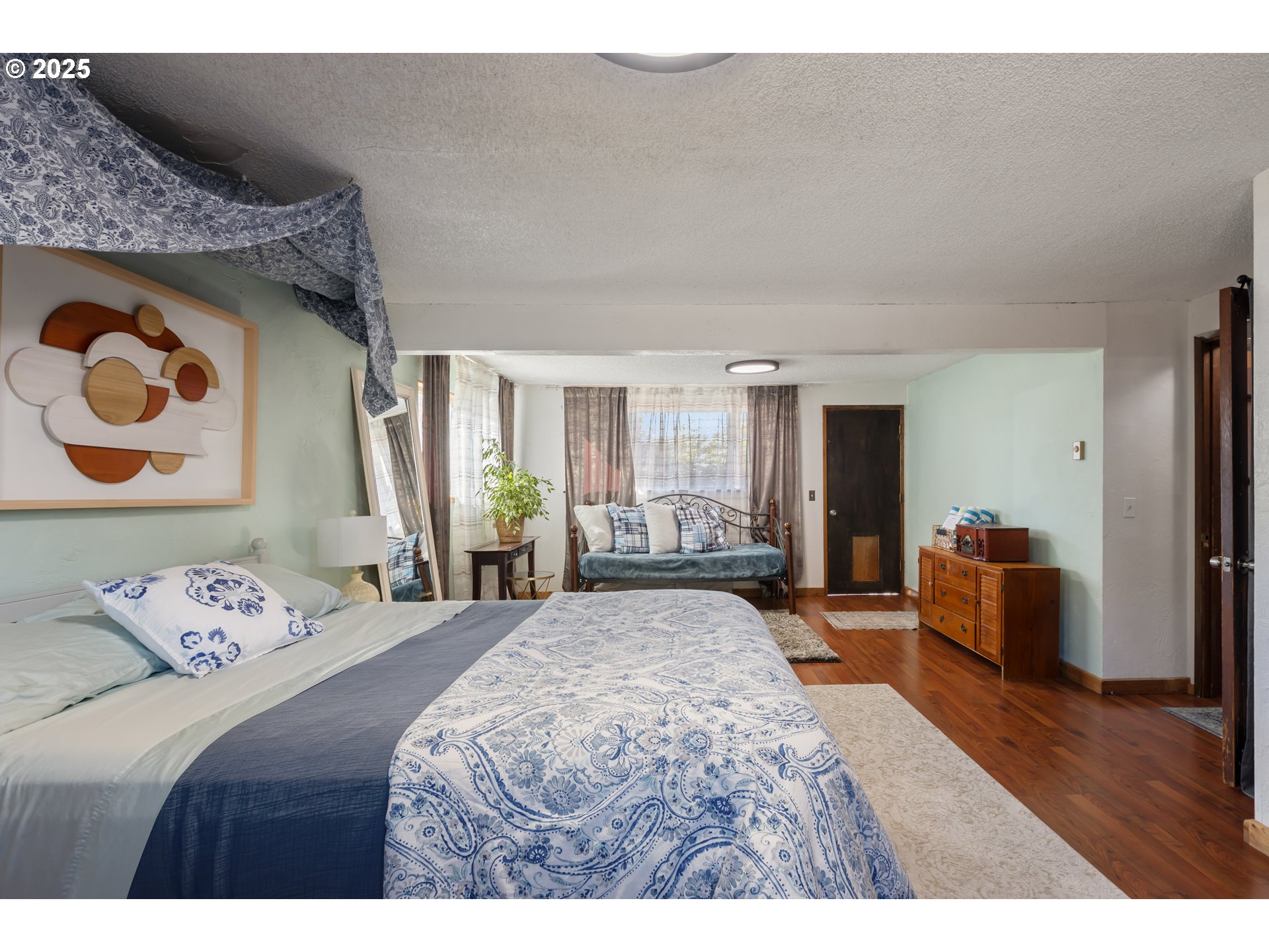 930 Prescott Lane Springfield, OR 97477 - Photo 19 of 31 a bedroom with a bed and wooden floor