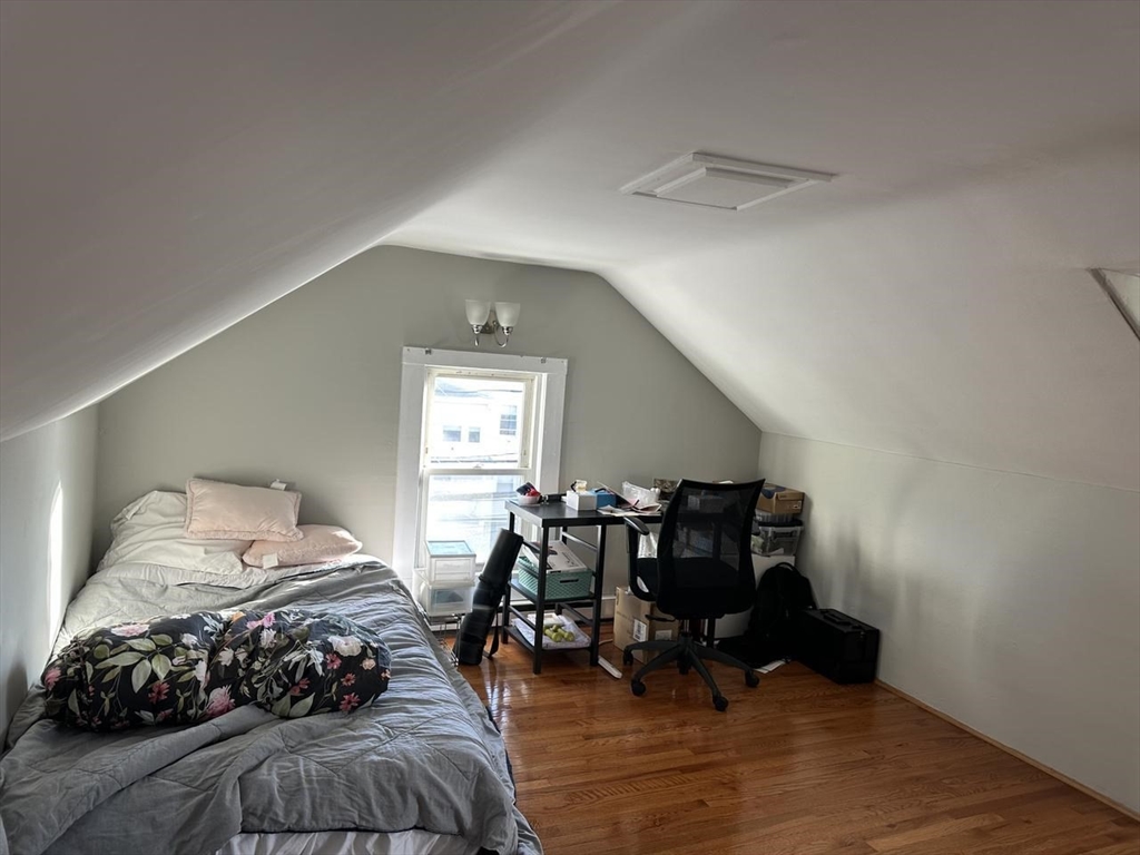 123 Faneuil Street, Unit 2 Boston, MA 02135 - Photo 11 of 12 a bedroom with furniture and a wooden floor