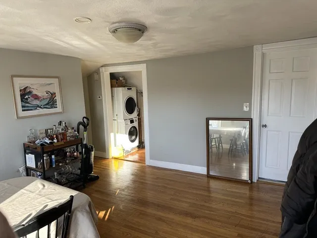 a view of a hallway with wooden floor and furniture