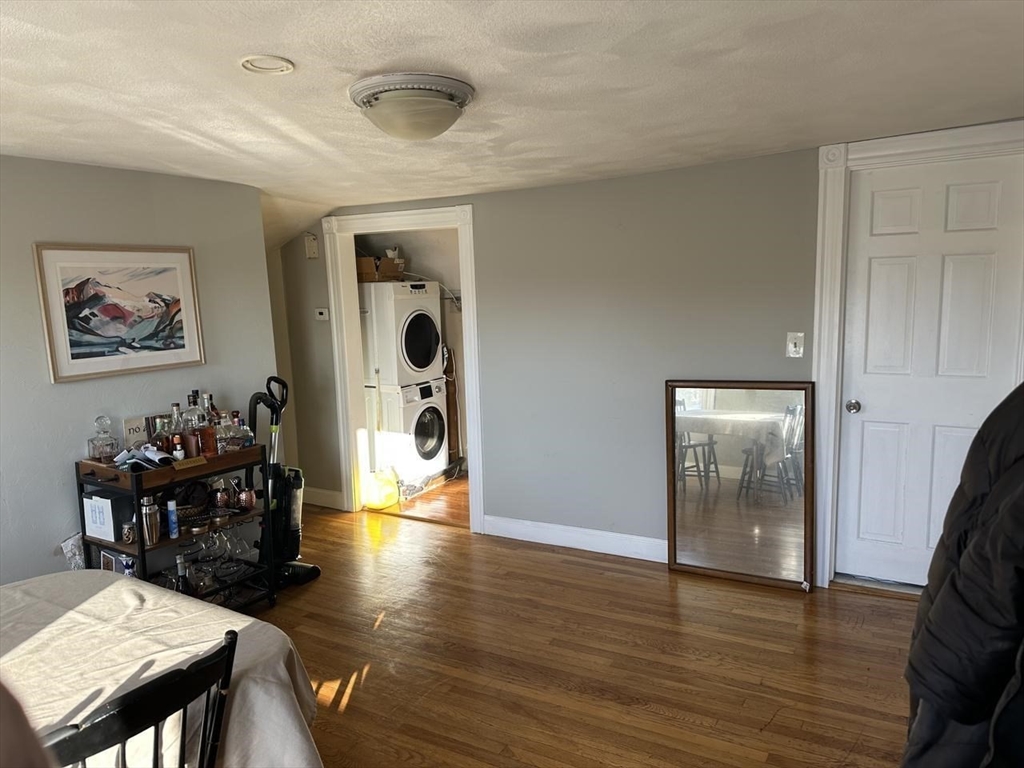 123 Faneuil Street, Unit 2 Boston, MA 02135 - Photo 5 of 12 a view of a hallway with wooden floor and furniture