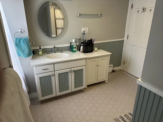 a bathroom with a double vanity sink and a mirror