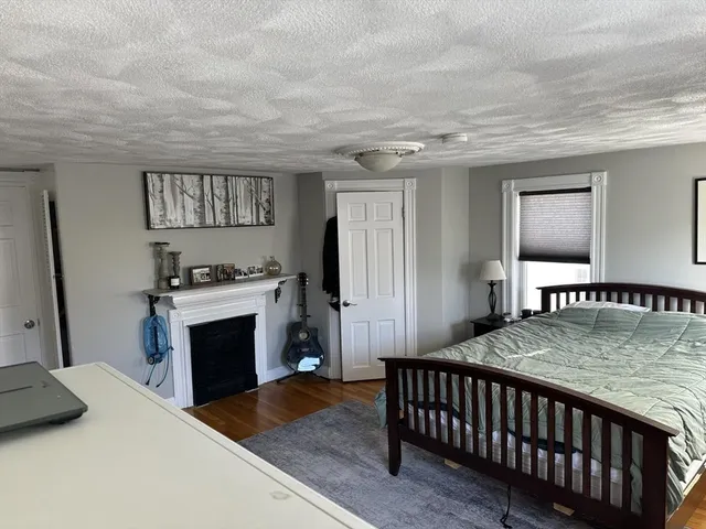 a bedroom with furniture and a fireplace