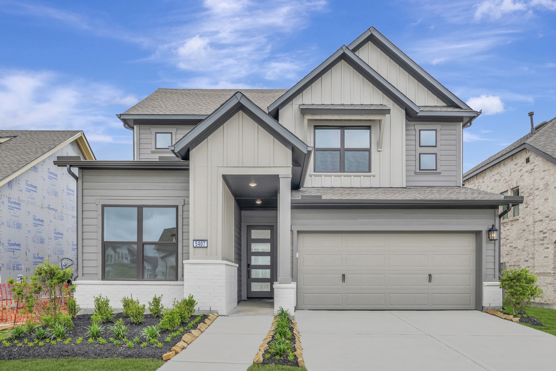 a front view of a house with garage
