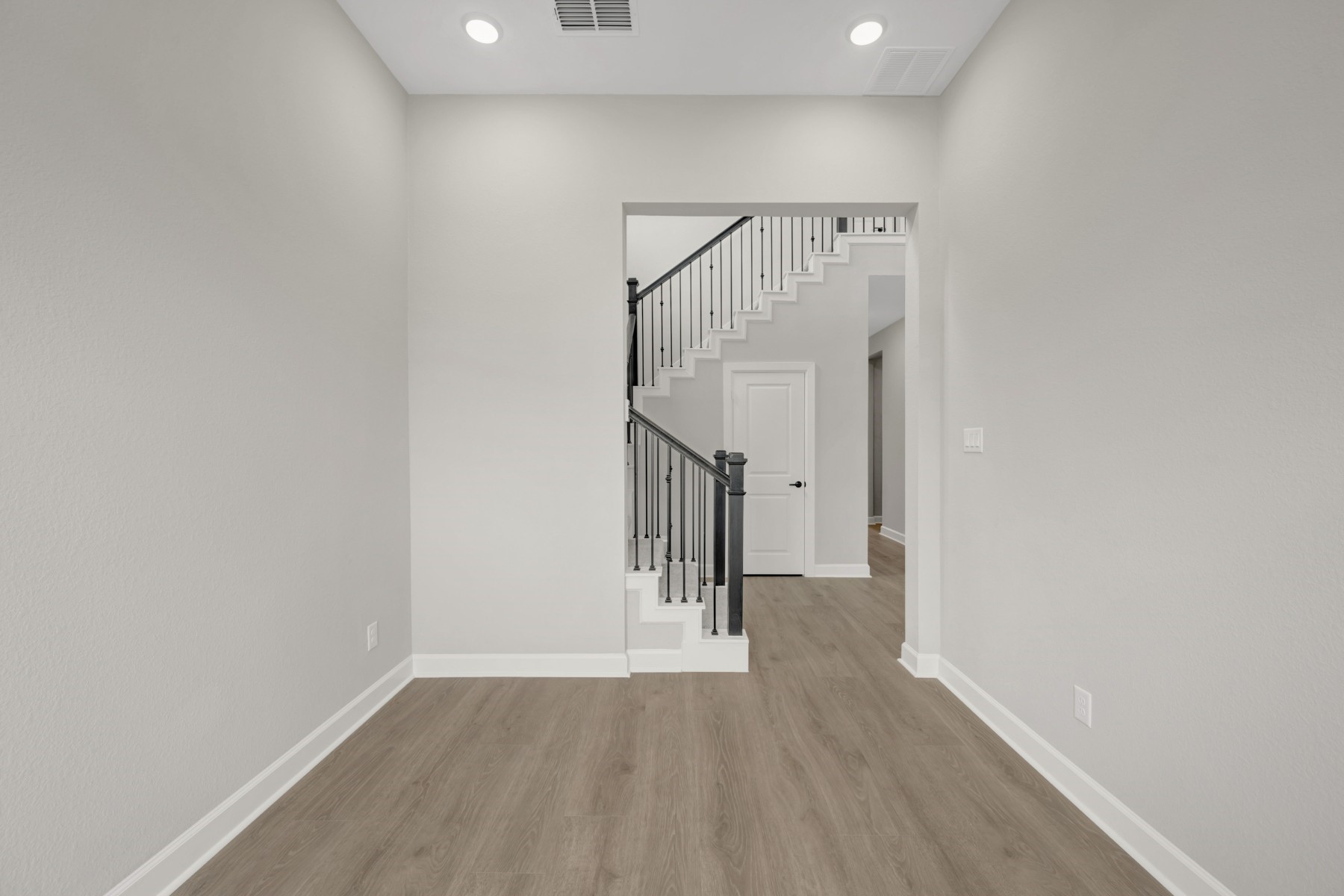 5407 Mango Blfs Street Manvel, TX 77578 - Photo 16 of 50 a view of hallway with stairs and wooden floor