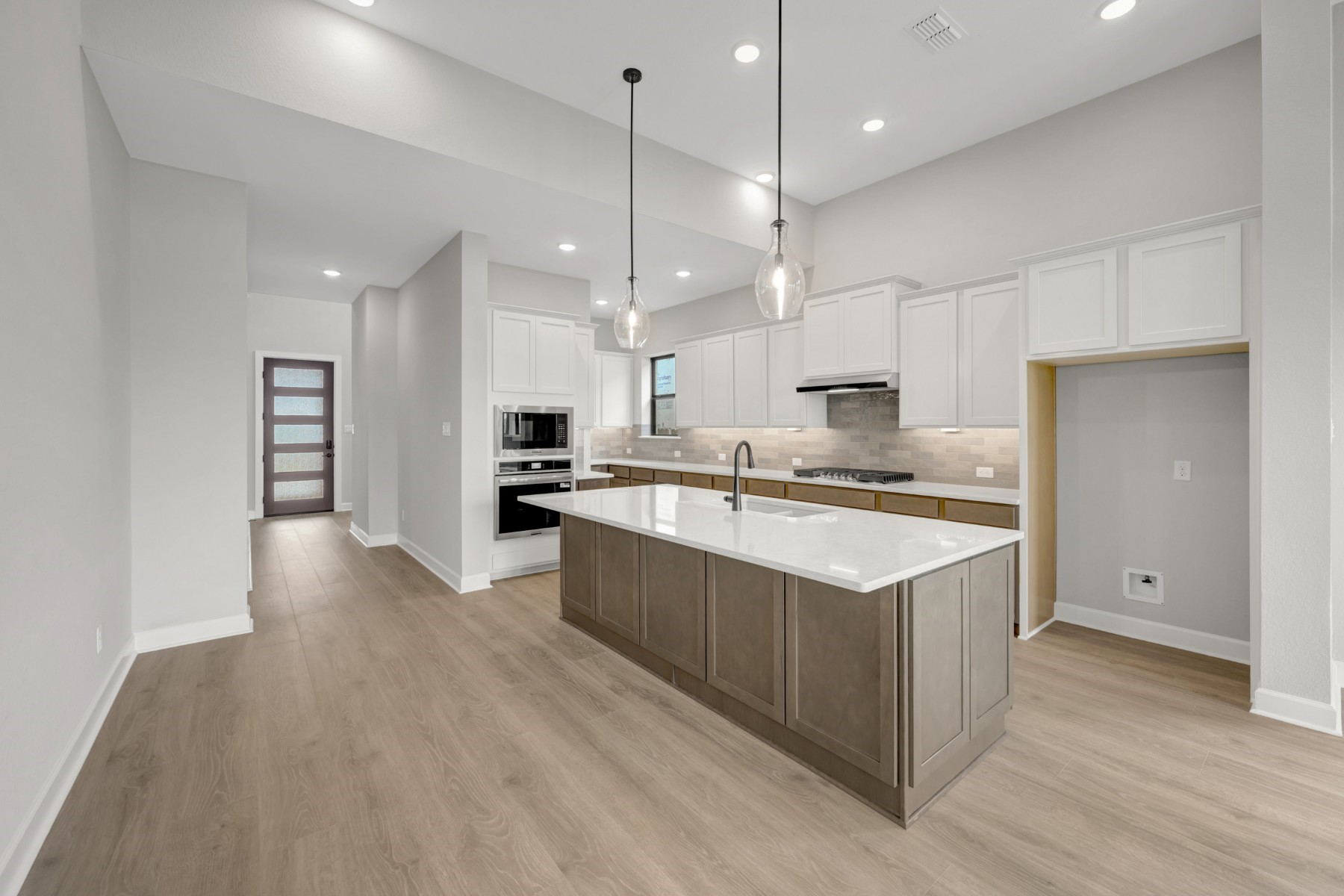 5407 Mango Blfs Street Manvel, TX 77578 - Photo 20 of 50 a large kitchen with stainless steel appliances kitchen island a large counter top and a wooden floors