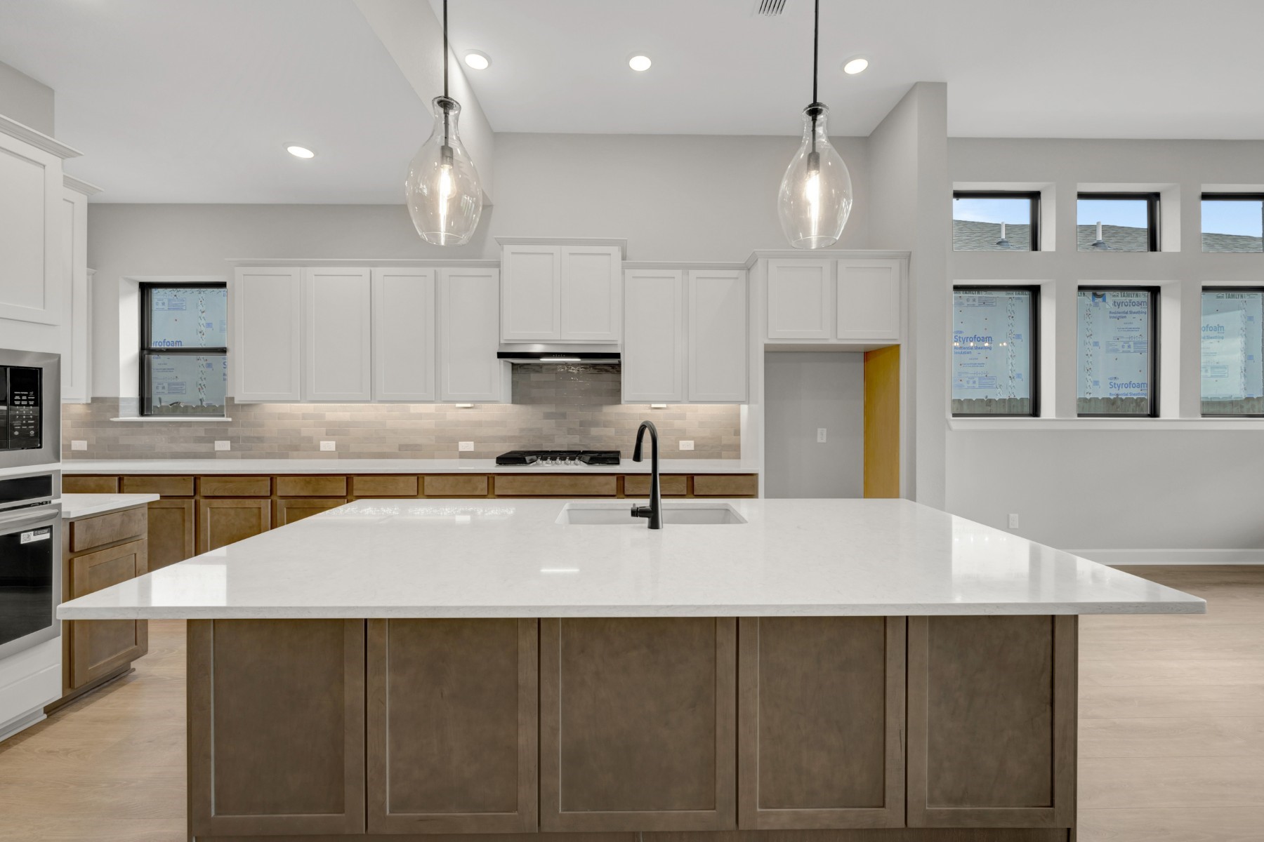 5407 Mango Blfs Street Manvel, TX 77578 - Photo 23 of 50 a kitchen with kitchen island a counter top space cabinets and stainless steel appliances