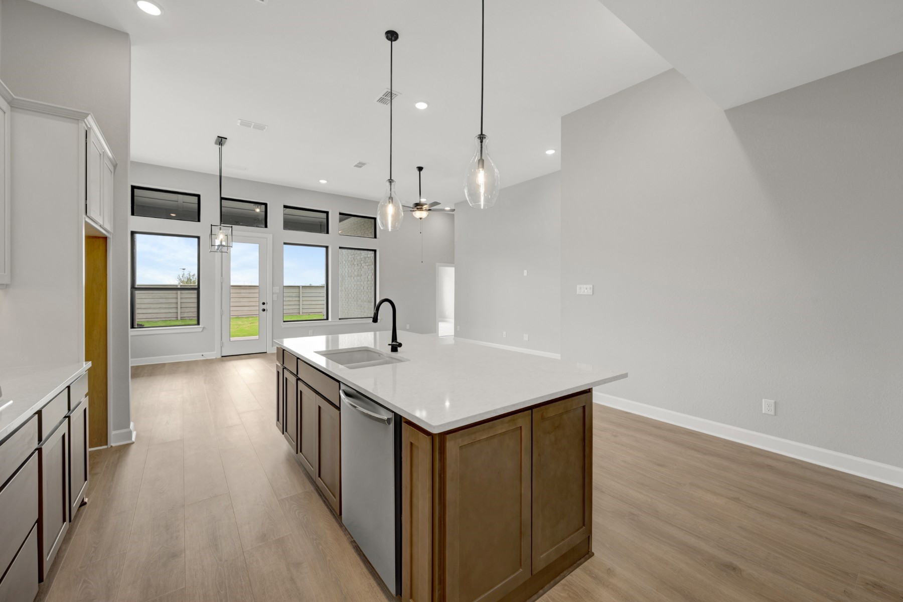 5407 Mango Blfs Street Manvel, TX 77578 - Photo 27 of 50 a kitchen with a sink a counter space wooden floor and stainless steel appliances