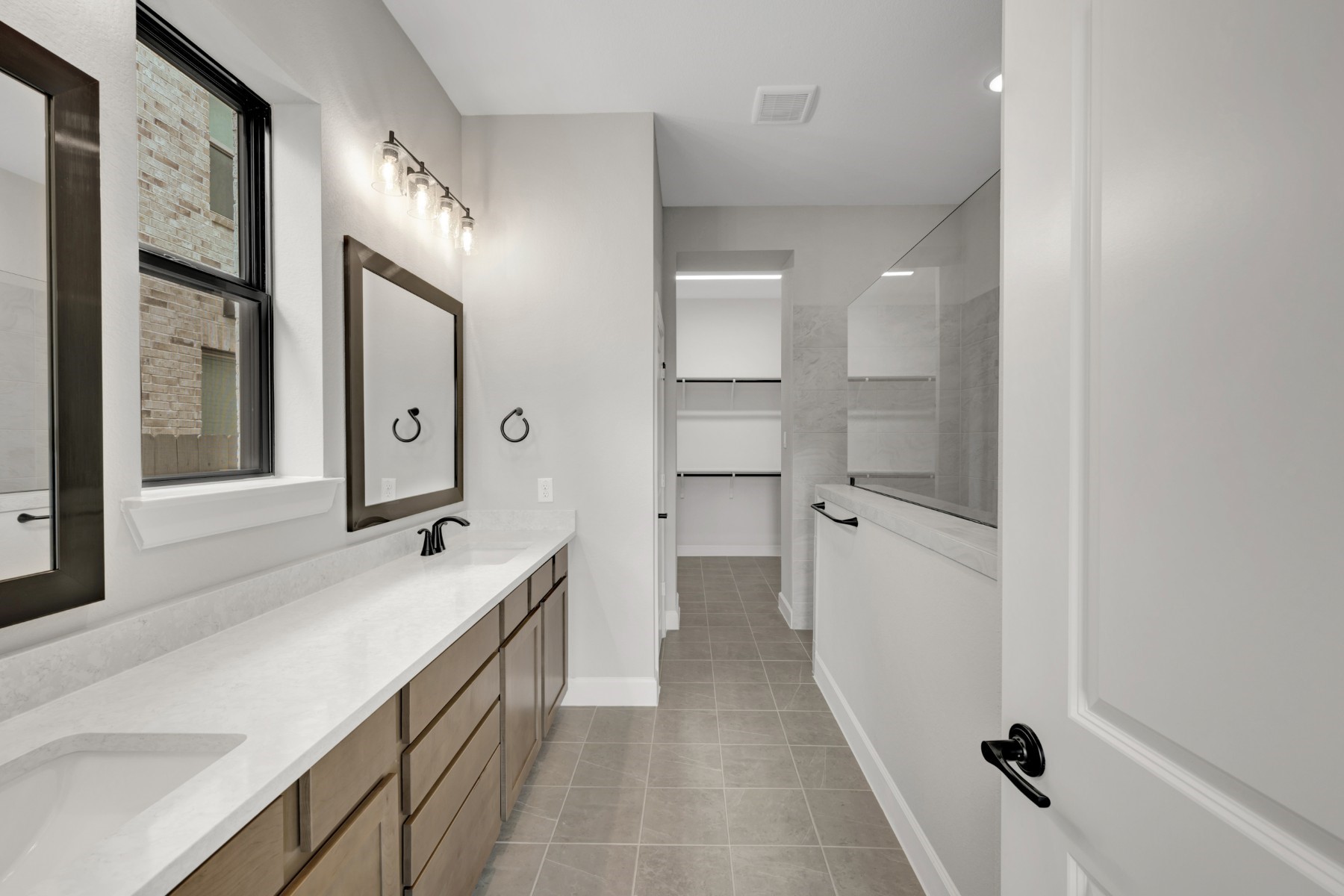5407 Mango Blfs Street Manvel, TX 77578 - Photo 35 of 50 a bathroom with a double vanity sink a mirror and a shower