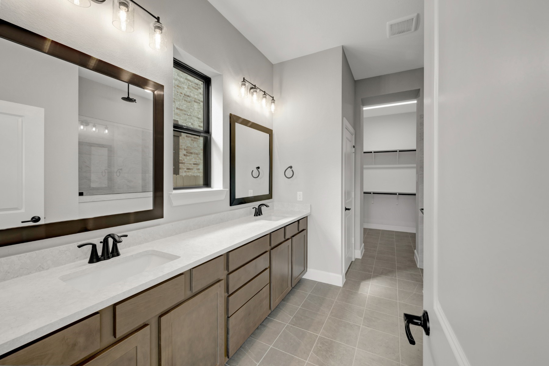 5407 Mango Blfs Street Manvel, TX 77578 - Photo 36 of 50 a spacious bathroom with a double vanity sink mirror and